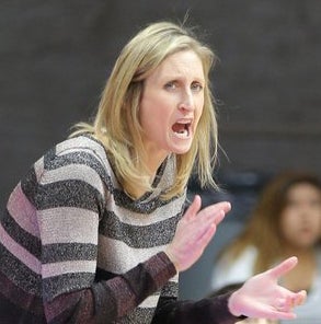 Coach Jen Gross claps hands on sideline.