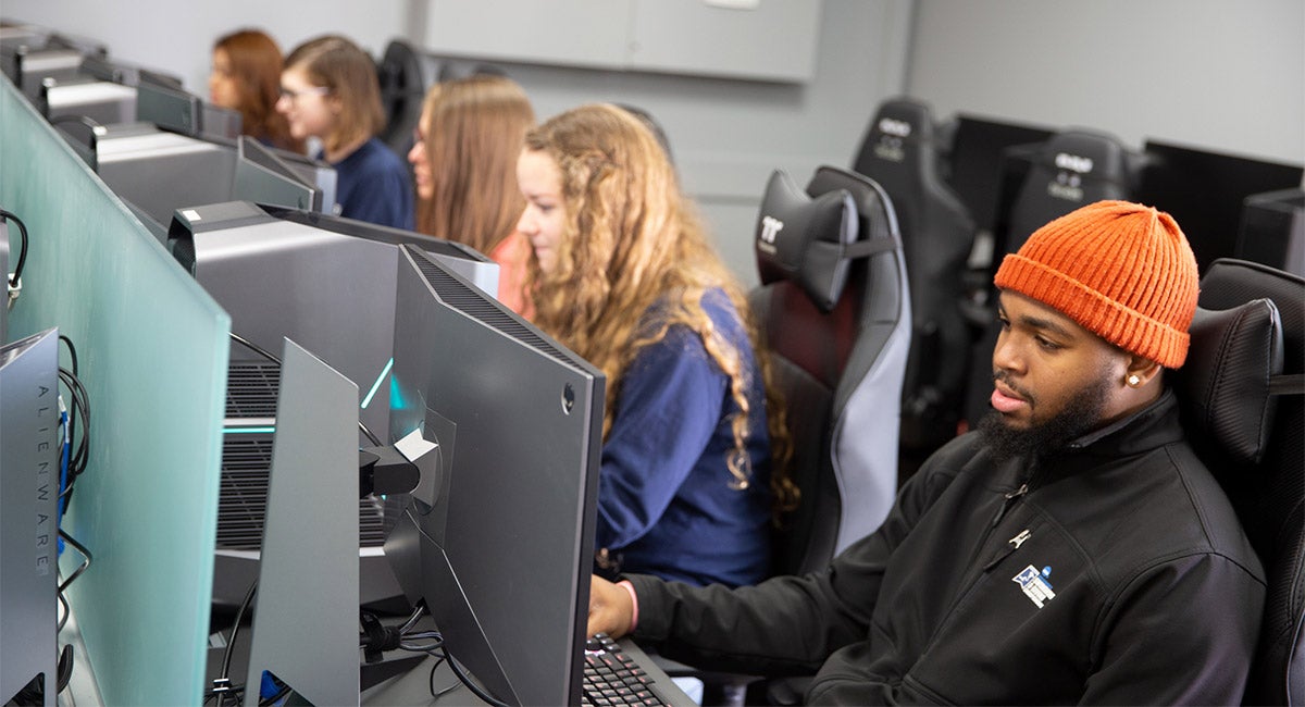 Students sit at computers.