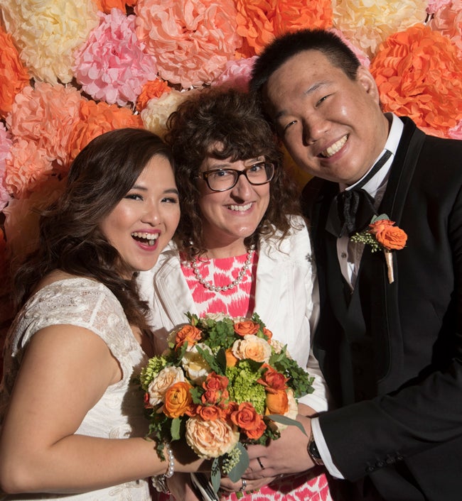 Corbett, San and Mu lee with flowers at wedding