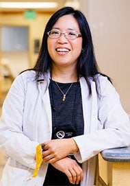 Elisa Tong in lab coat