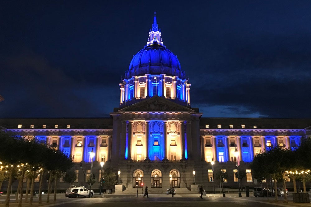 San Francisco City Hall lit in blue and gold.