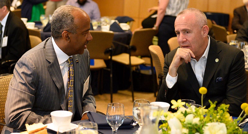 Chancellor Gary S. May talks with Darrell Steinberg at a lunch.