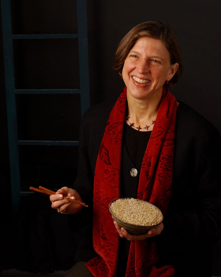 Pam Ronald holds bowl of rice and chopsticks.