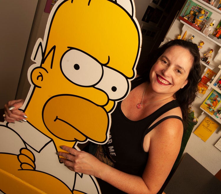 Karma Waltonen poses with bigger-than-life Bart Simpson cutout.