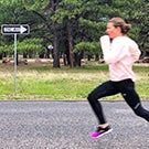 Kim Conley runs in the opposite direction of a "one way" sign.