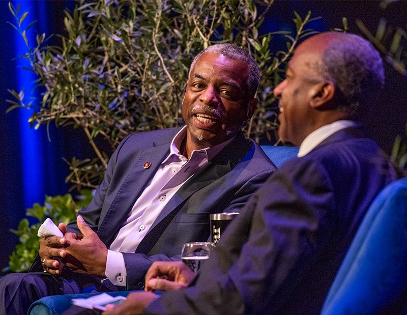 Close-up photo of LeVar Burton and Gary S. May sitting on stage.