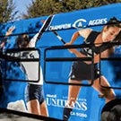 A bus wrapped with photos of athletes