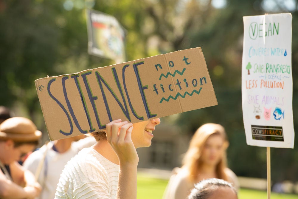 Climate striker holds sign, "Science, not fiction."
