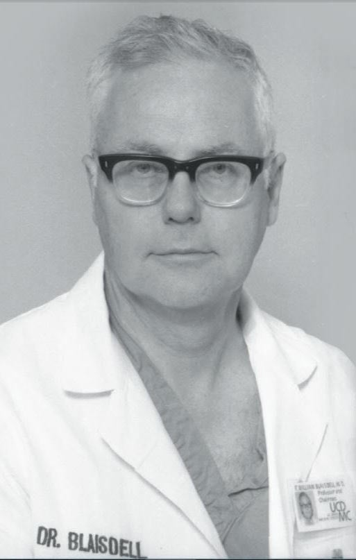 F. William Blaisdell in lab coat, black and white