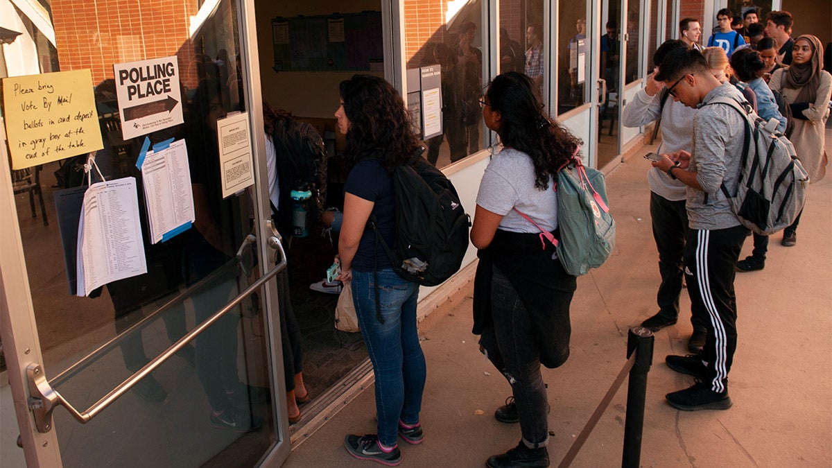 Students wait in line to vote.