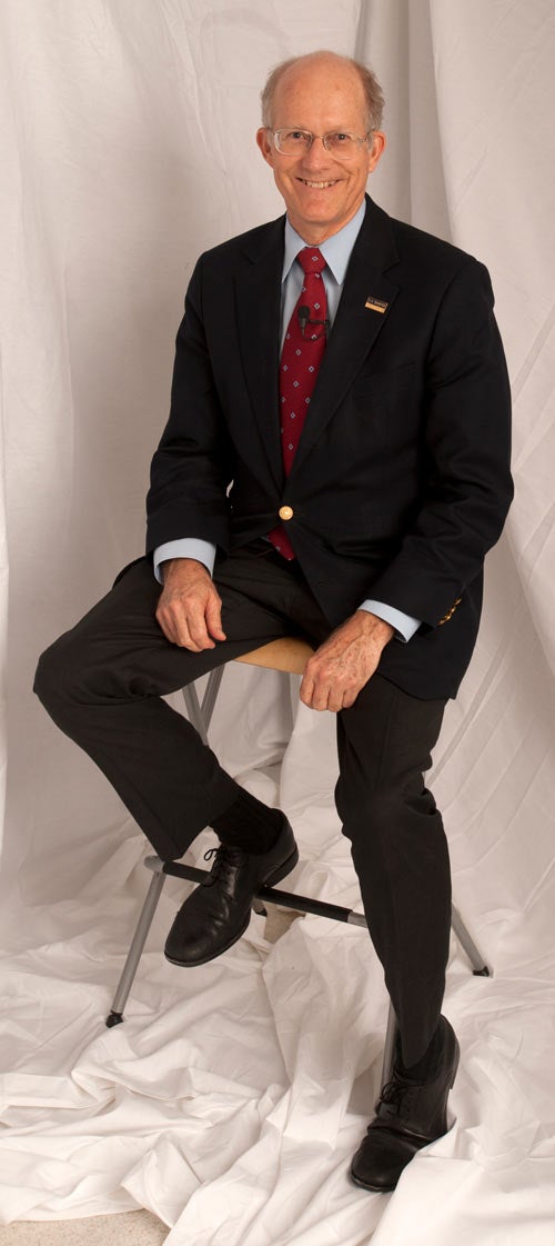 Ken Burtis, formal, sitting on stool.