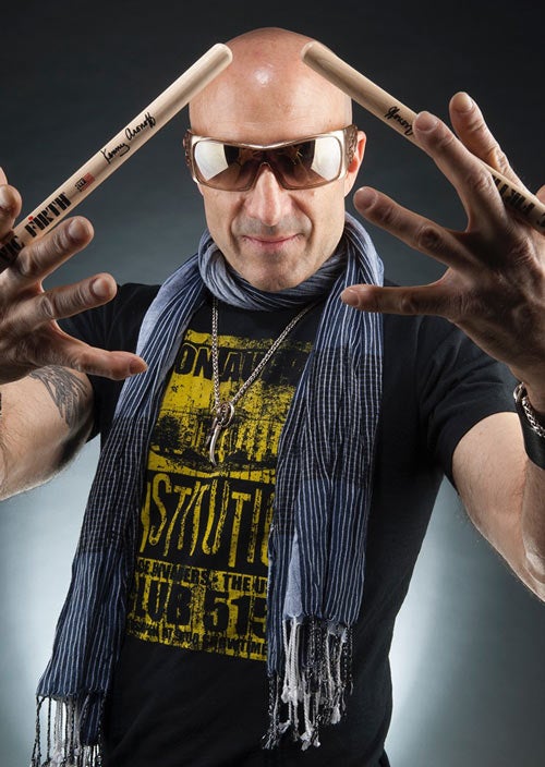 Kenny Aronoff holds drumsticks.