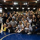 Women's basketball team poses for photo.