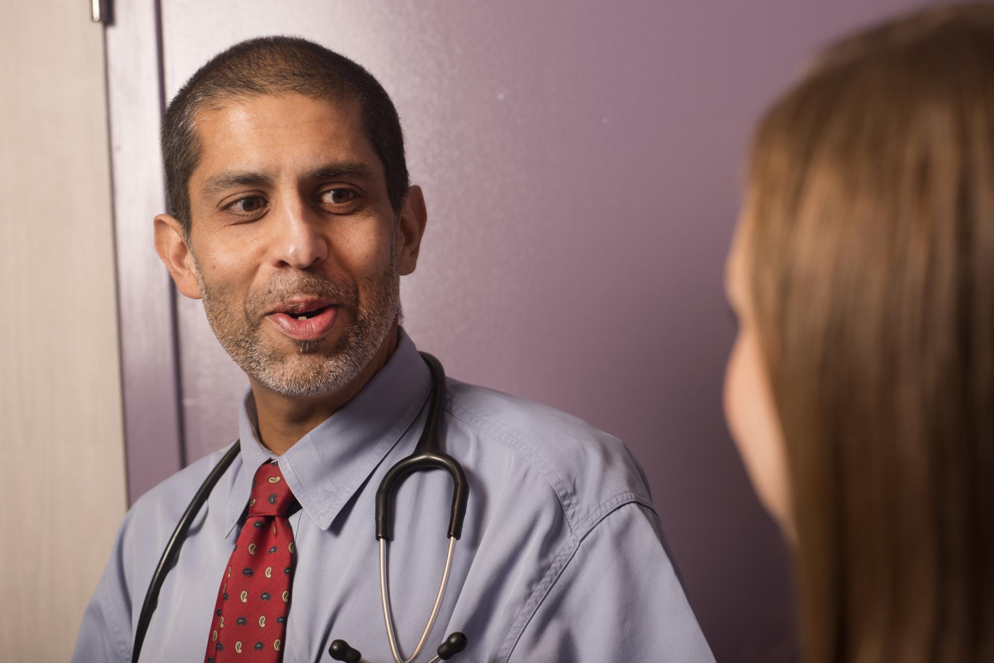A male doctor talks with a patient