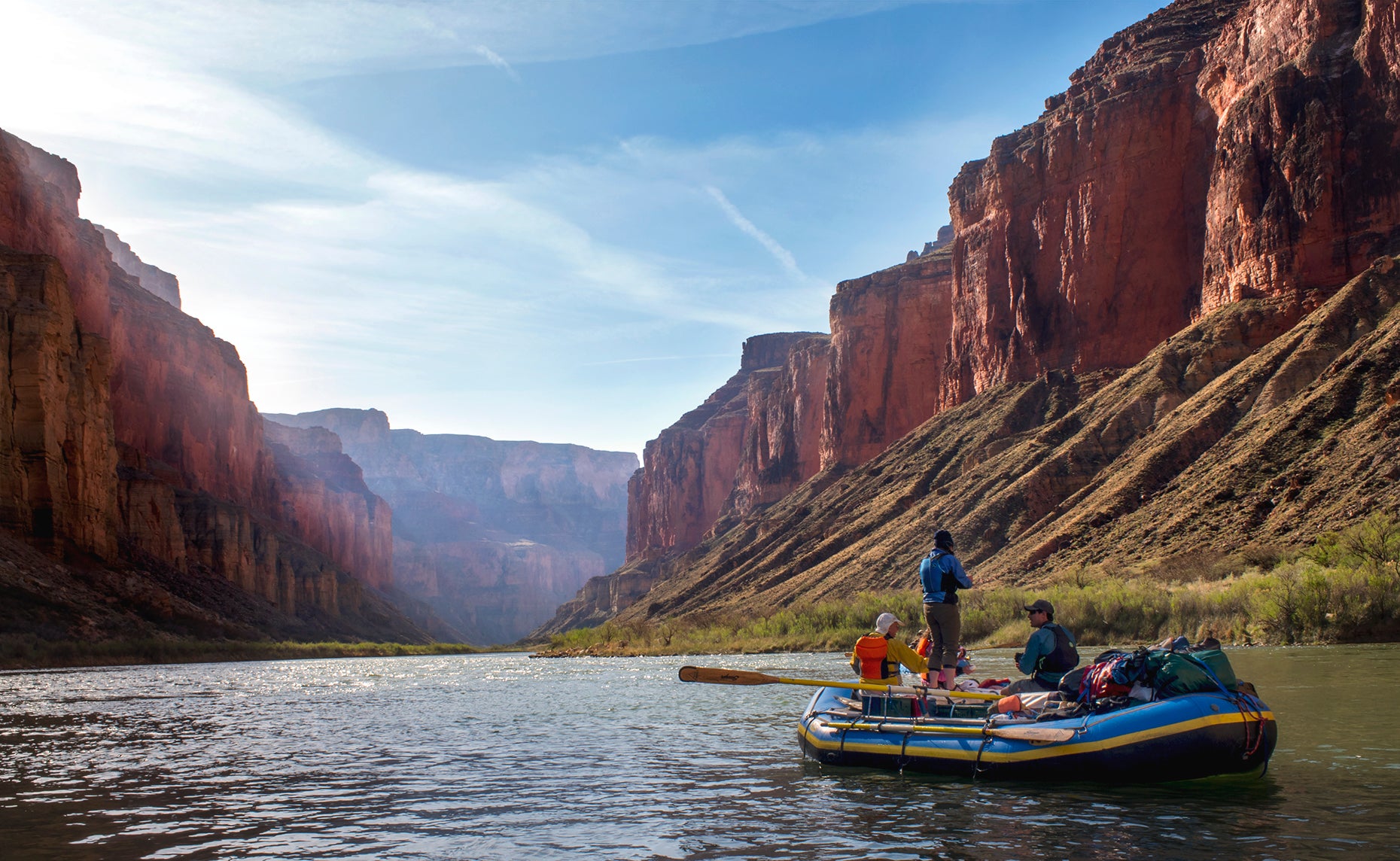 Two men and woman in raft in Grand Canyon