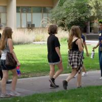 a group of people being on a student-led tour of campus