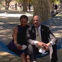 Chancellor May and LeShelle sitting in a hammock in the UC Davis quad