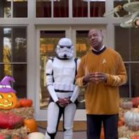 Chancellor Gary May stands with a Stars Wars stormtrooper outside in front of halloween decorations with instagram graphics over top