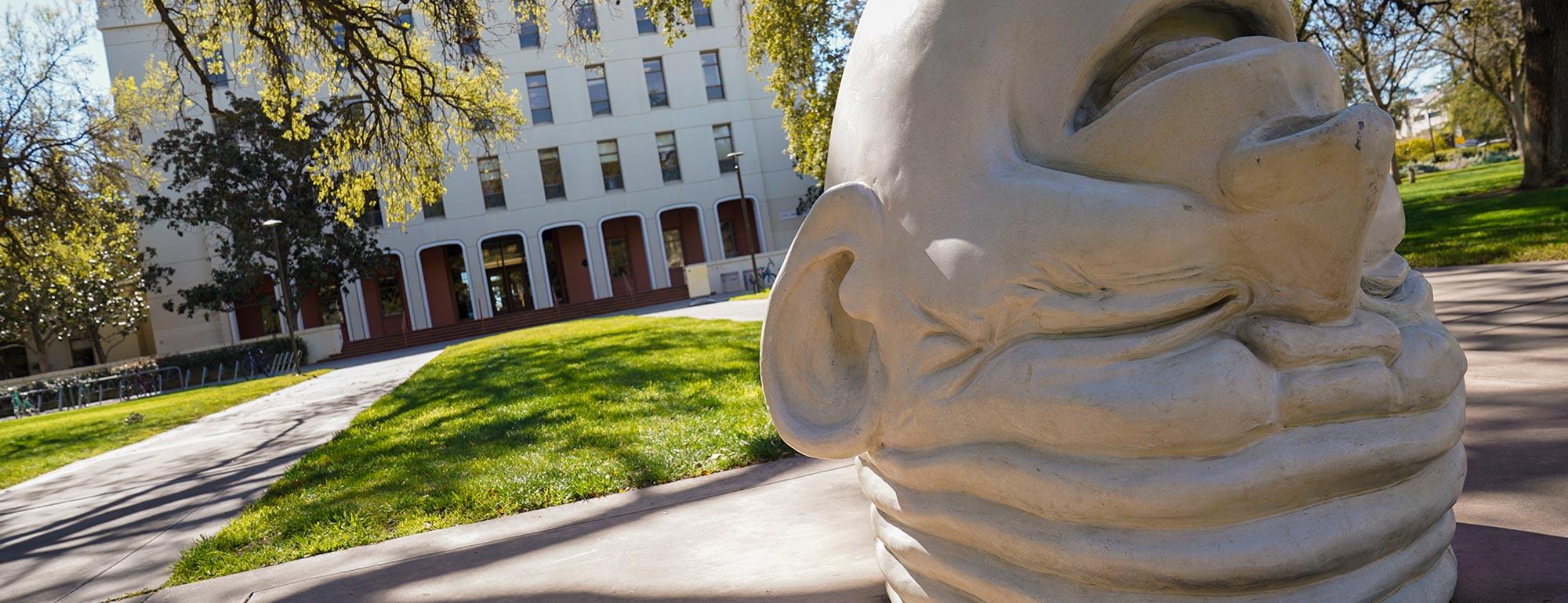 A view of the Egghead sculpture, Eye on Mrak in front of the Mrak Hall