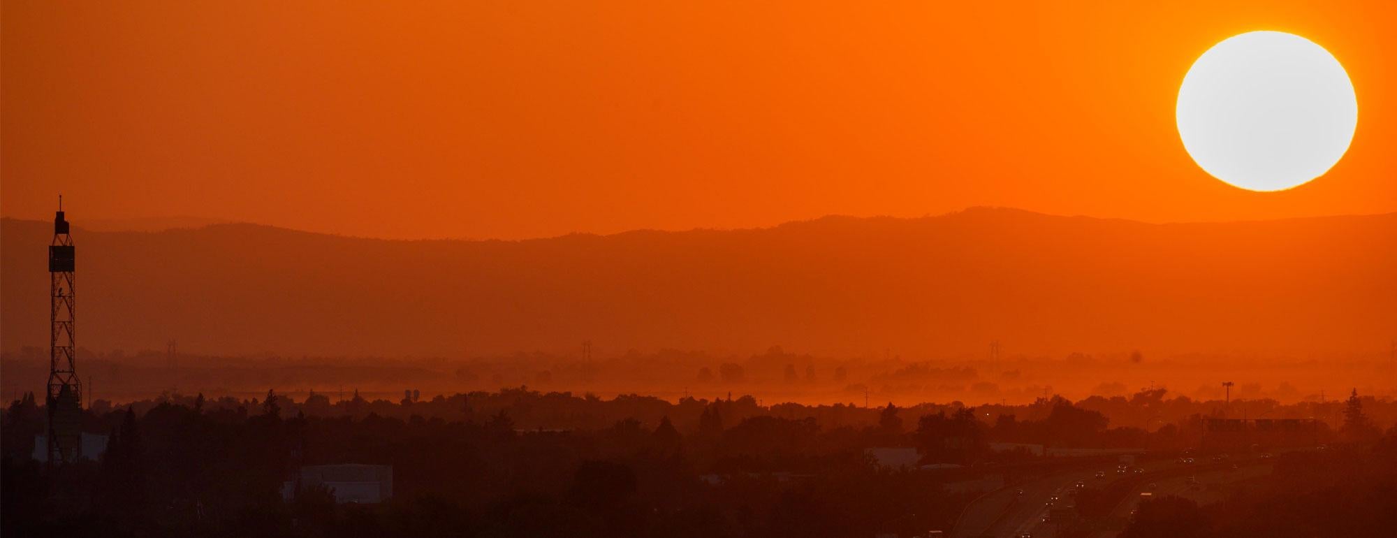 The sun sets over a extremely hot day in the Sacramento region.