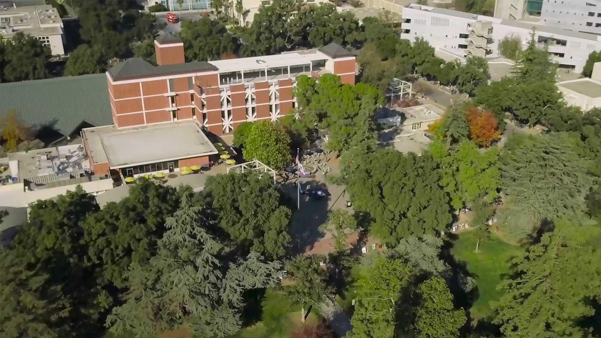aerial view of the UC Davis campus showing some buildings surrounded by trees