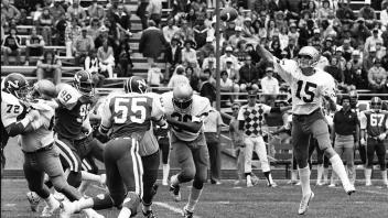 A UC Davis quarterback throws the ball in a 1980 football game