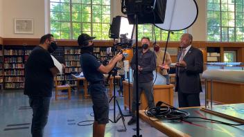 Chancellor May and film crew working in Shields Library.