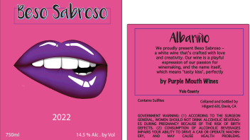 A hot pink label with a purple-lipped mouth biting its lower lip. The label reads: Beso Sabroso. 2022. 750ml. 14.5% Alc. by Vol. Followed by a description of the wine and a government warning.