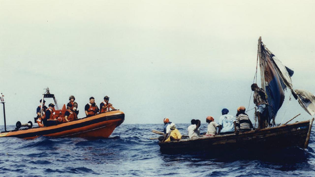 Wooden boats carrying migrants at sea, from book cover.