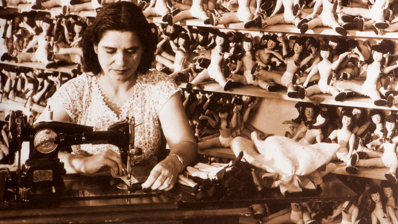 Woman works at sewing machine, from cover of "he Oxford Handbook of American Women&rsquo;s and Gender History."