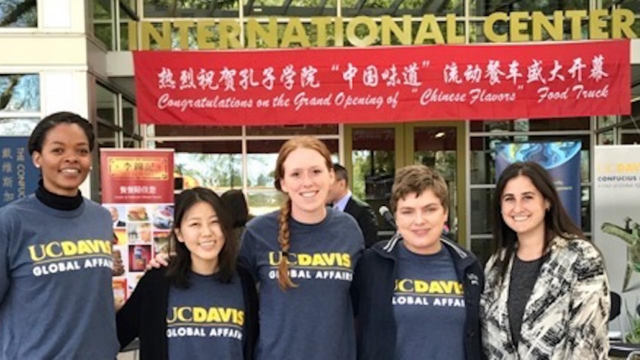Global Affairs Student Assistants support the opening of the Chinese Flavors Food Truck in front of the International Center 