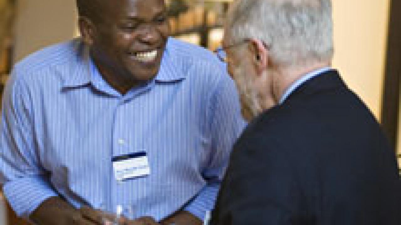 Peter Mutinda Mutua of Kenya shares a laugh with William Lacy, Vice Provost of University Outreach and International Programs, at a Feb. 3 Chancellor's Reception for the Humphrey and Fulbright fellows.