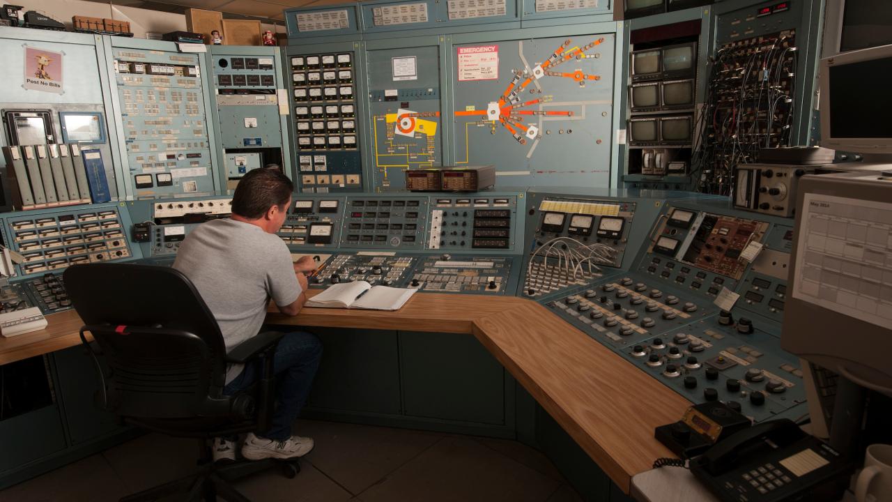 Cyclotron operator in control room.