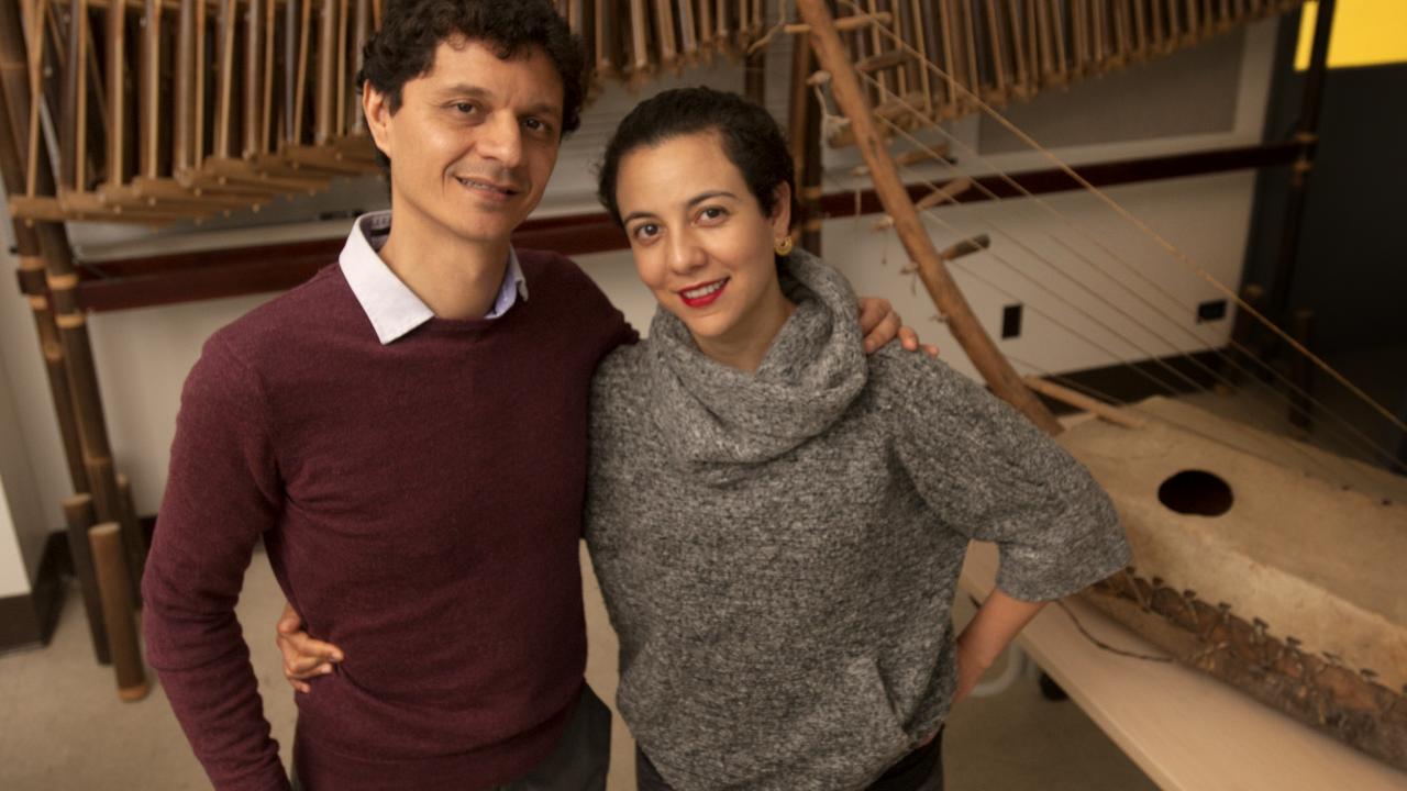 Music Professor Juan Diego D&iacute;az and his wife, Yerina Rock, are pictured in a music room.
