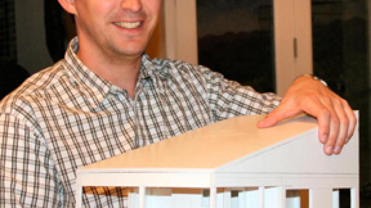 Aspiring architect Aaron Pyle shows off a scale model that he is building for a house that he designed.