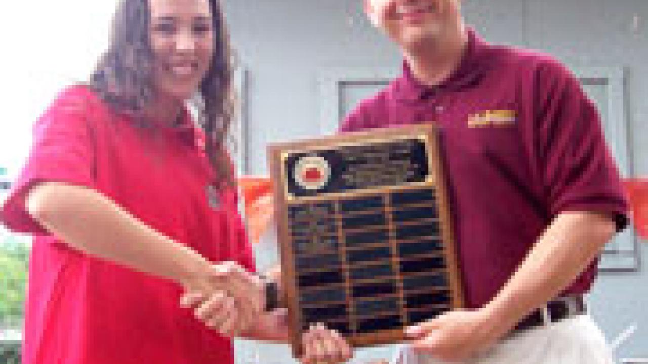 Elizabeth Guerra, representing the first-place anthropology department, poses with Lt. Col. Mark W. Connelly, chair of military science, after the May