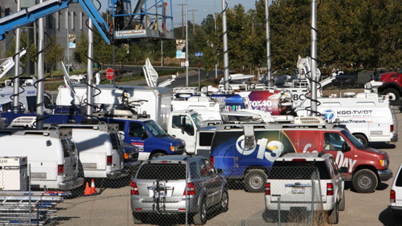 Photo: TV trucks, many with their satellite masts raised, filled the dirt lot that is kitty-corner from the Modavi Center for the Performing Arts.