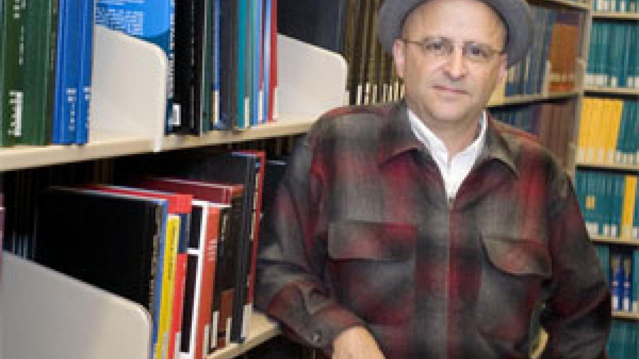 Photo: man in hat in library stacks