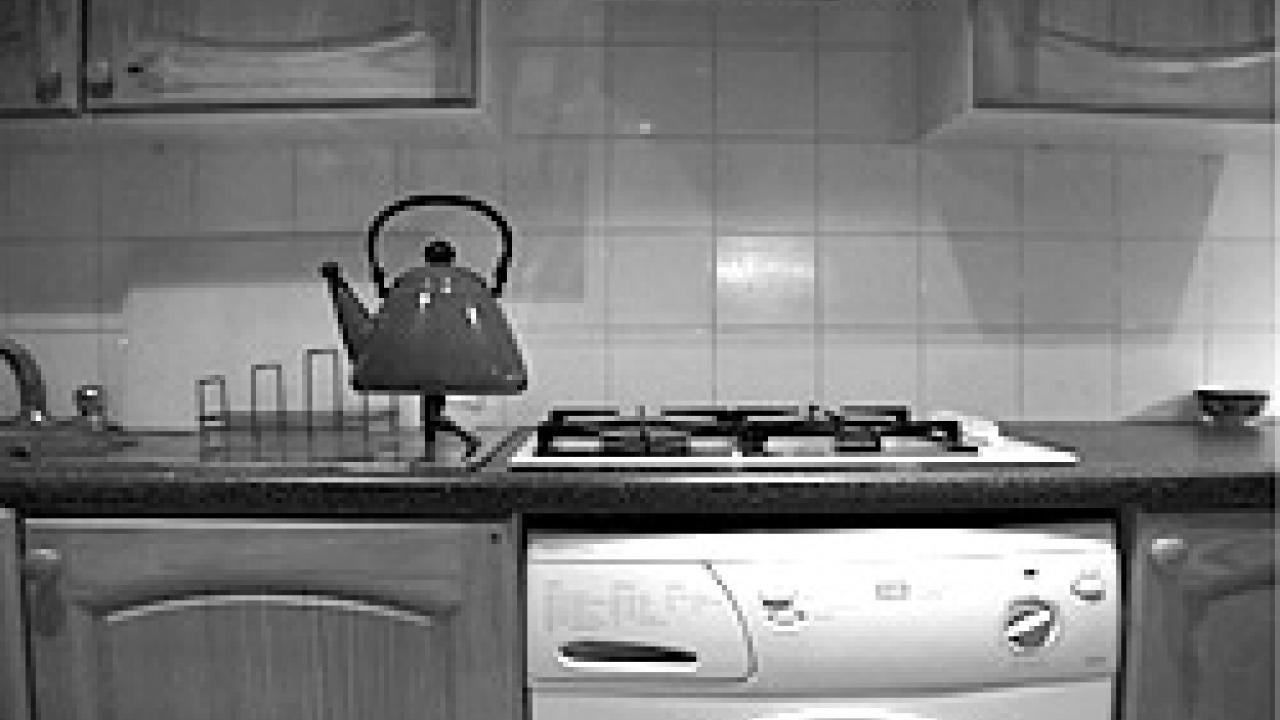 A frame from a Hiraki Sawa video shows a tea kettle with legs on his kitchen counter.