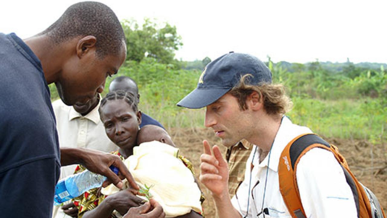 Michael Wolff, a UC Davis graduate student, right, discusses weeds with a volunteer in Kenya during a horticulture project in Kenya.