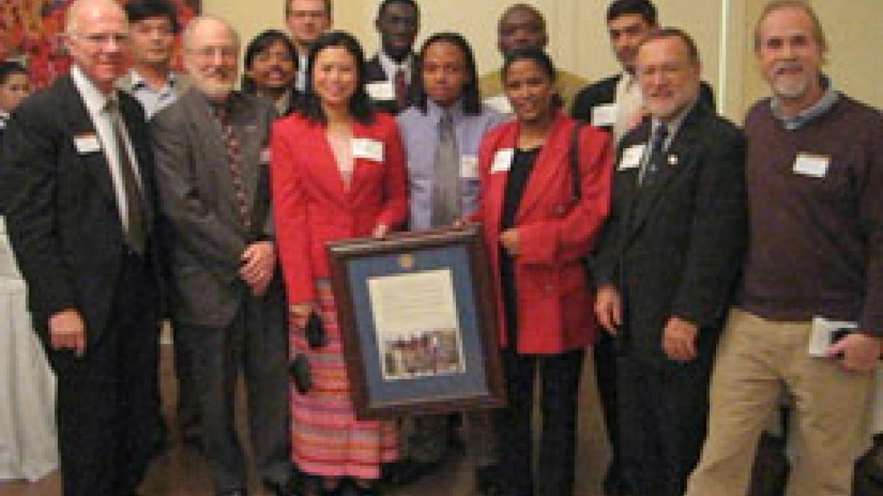 Humphrey Fellow program participants and coordinators present a commemorative version of their Principles of Community to Chancellor Larry Vanderhoef, left, and Vice Provost for University Outreach and International Programs Bill Lacy on Jan. 24