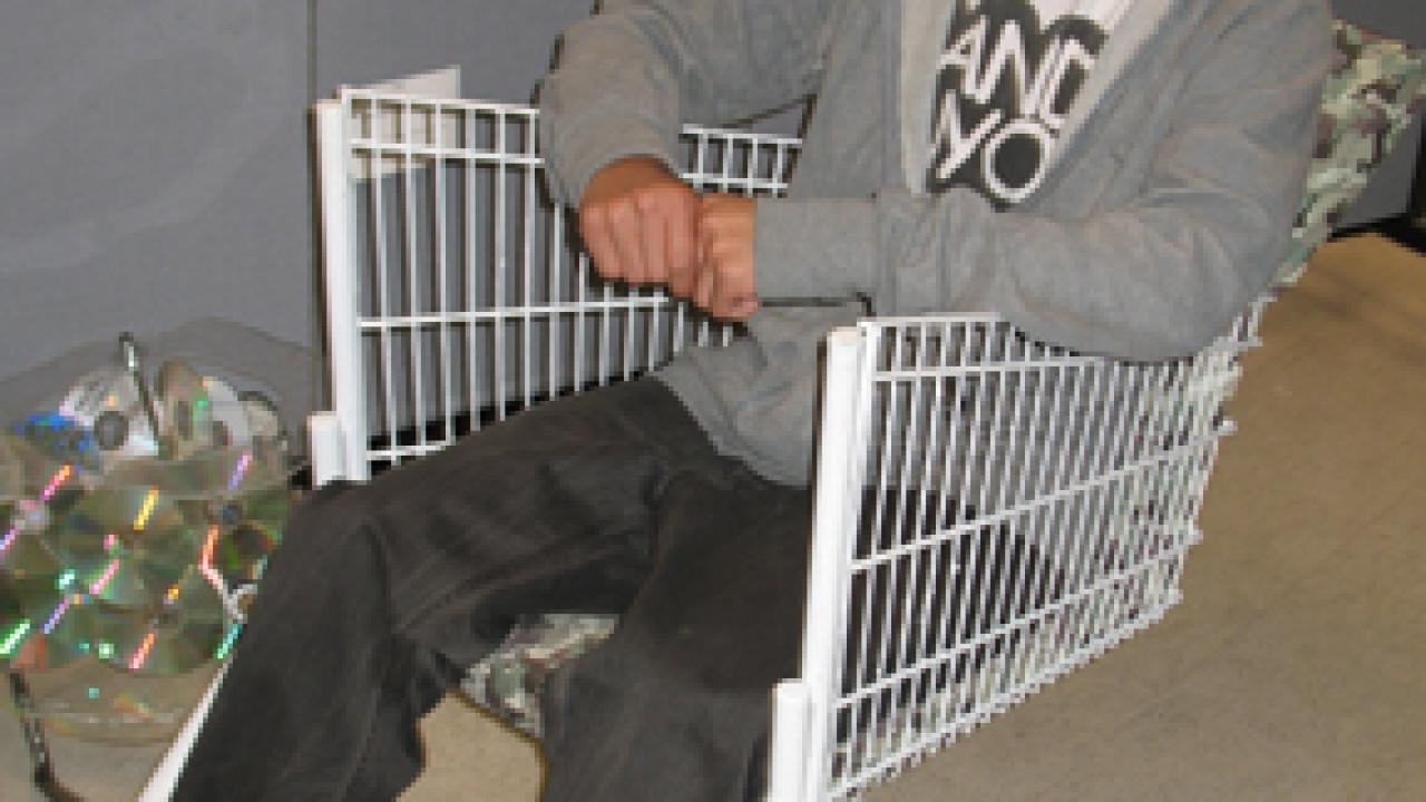 Third-year design student Tao Pang sits in the shopping cart that he turned into a chair.