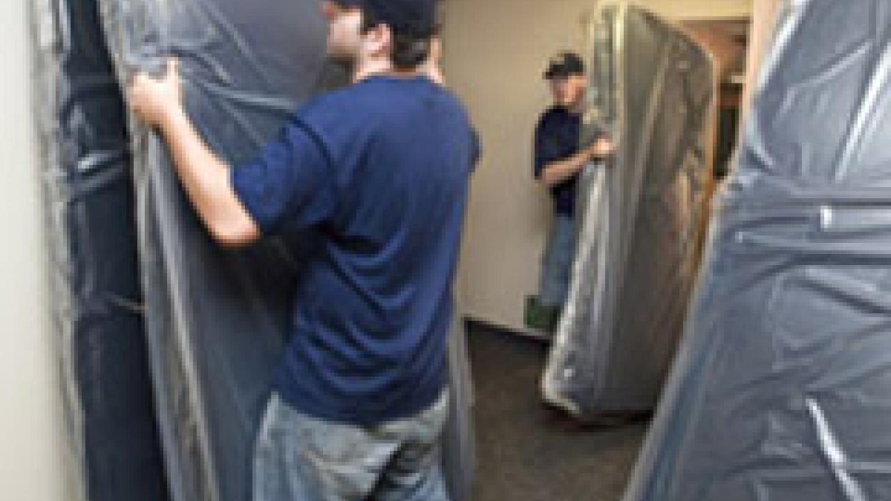 UC Davis students Scott McCormick, foreground, and James Keith were part of a crew that moved 200 new mattresses into two residence halls last week to