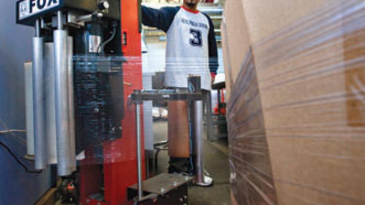 At Bulk Mail Services, senior mail processor Pravin Sharma uses a new machine that automatically wraps a pallet full of bulk mail; the pallets can then be moved easily by pallet jack. Previously, employees moved bulk mail in carts that weighed 7