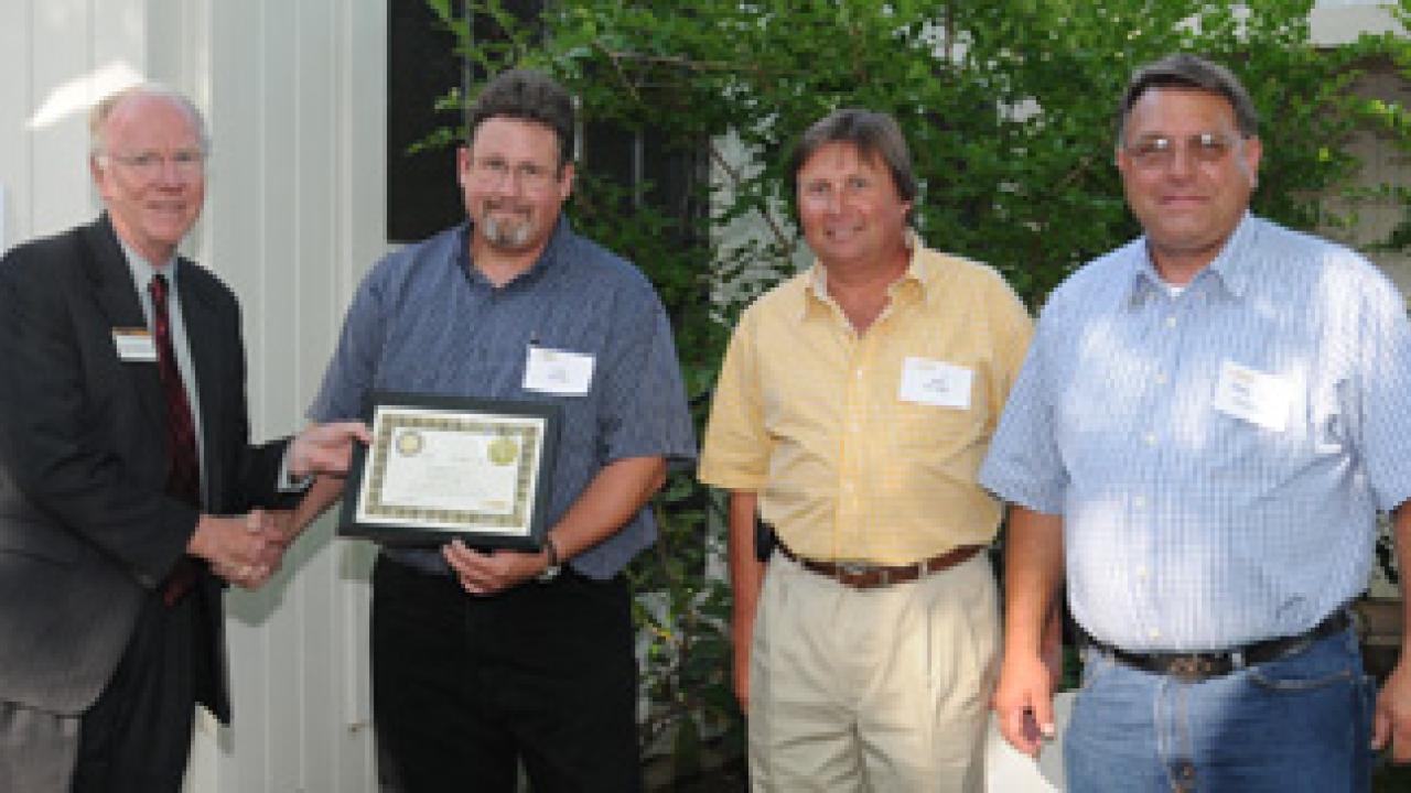 Chancellor Larry Vanderhoef and the Energy Management Team: Fred Haynes, Mark A. Nicholas and Mark D. Nicholas. 