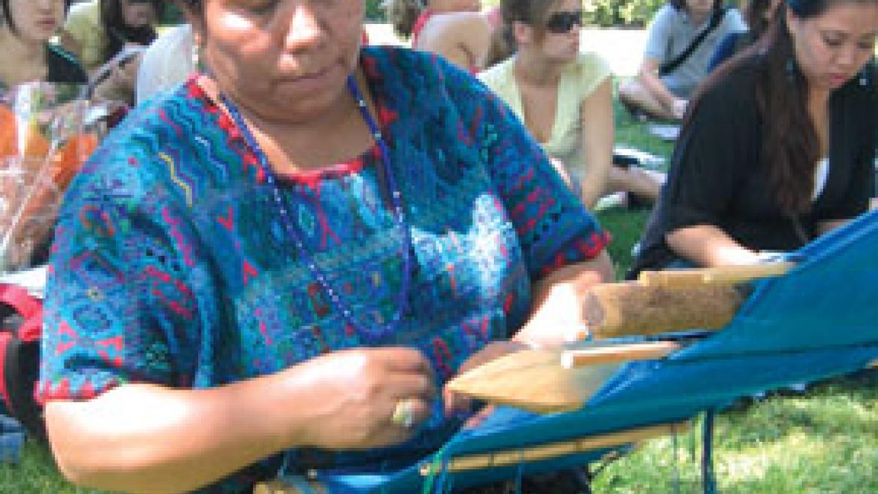 Bertina Lopez de Martin demonstrates the making of weft brocade fabric, which is used in the huipil, a traditional blouse for Mayan women.