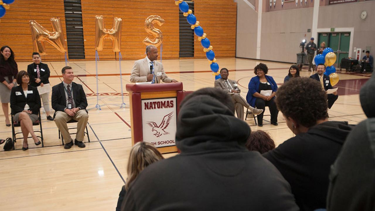 UC Davis Chancellor Gary S. May speaks to high school students in a gym