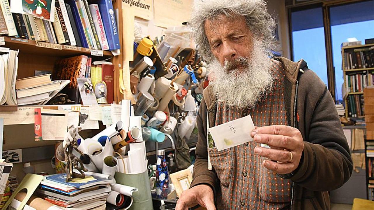 Art Shapiro holds an envelope containing a butterfly.