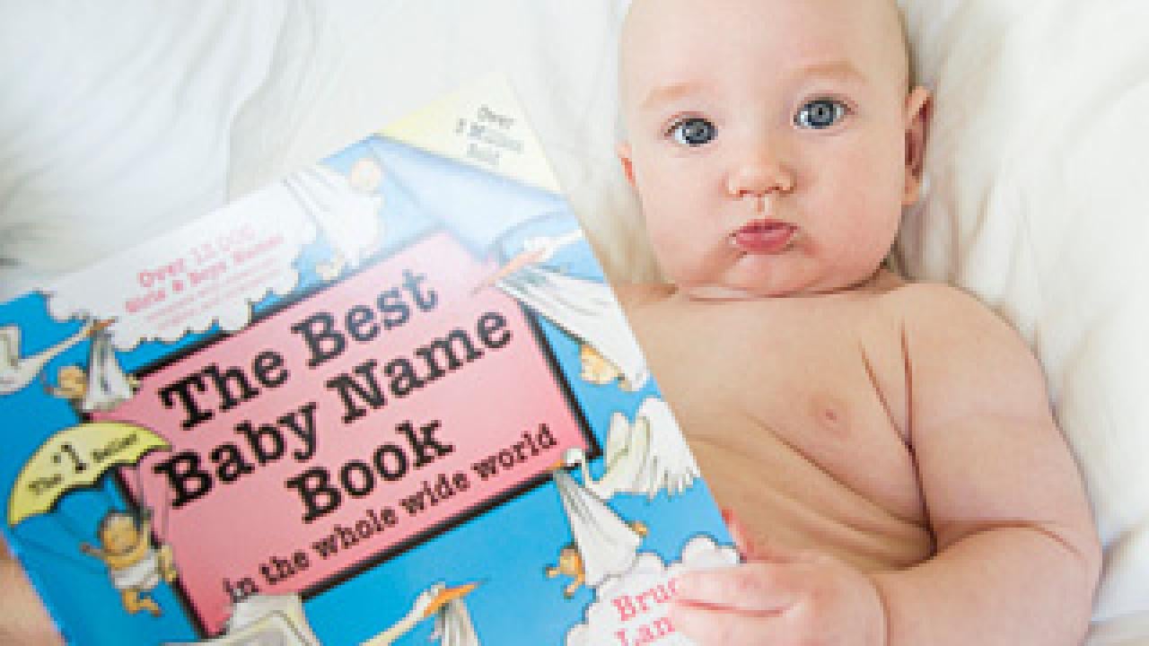 Baby holding "the Best Baby Name Book"
