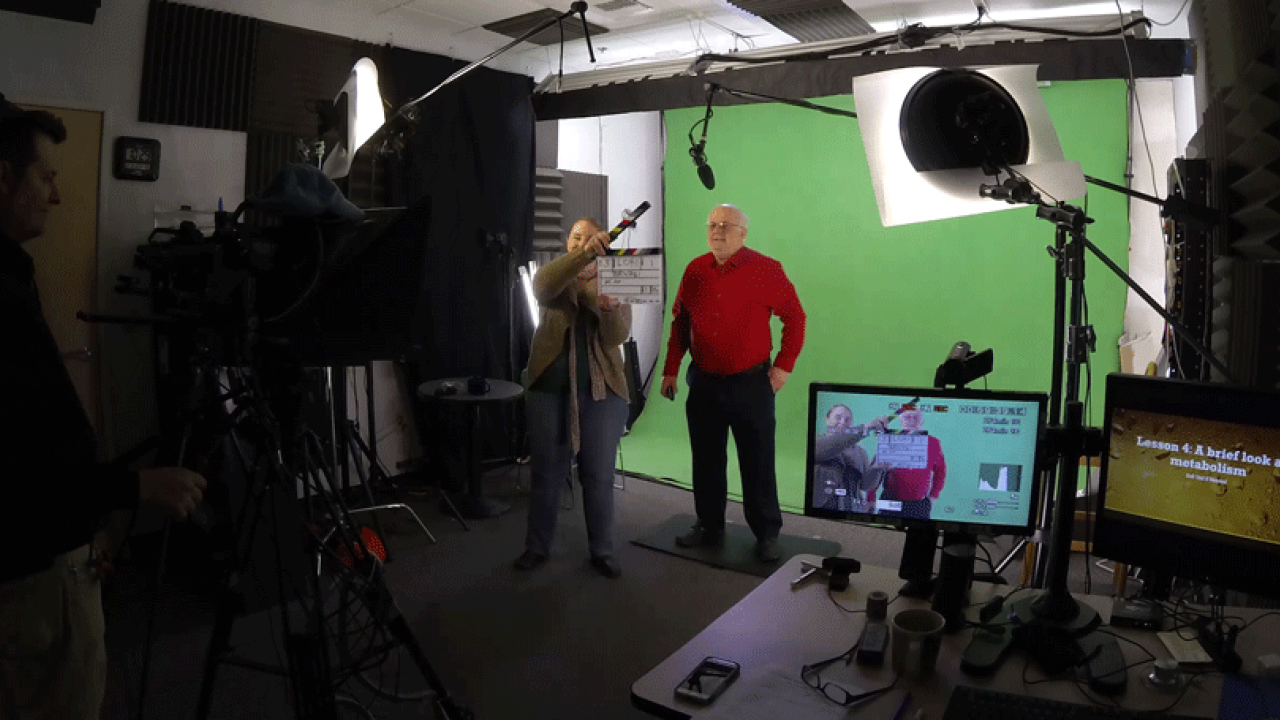 Charlie Bamforth stands in front of green screen.